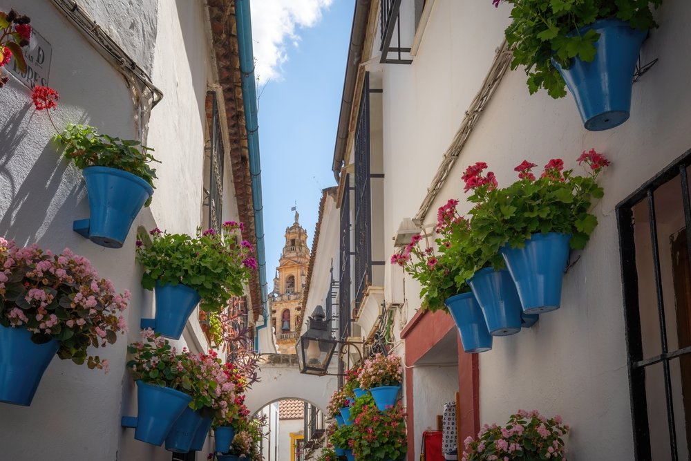 Calleja de las Flores i Judería i Córdoba med Mezquitas klokketårn i baggrunden