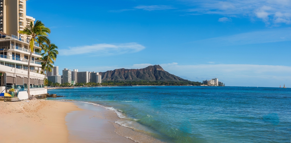 Waikiki Beach med palmer, hoteller og Diamond Head i baggrunden